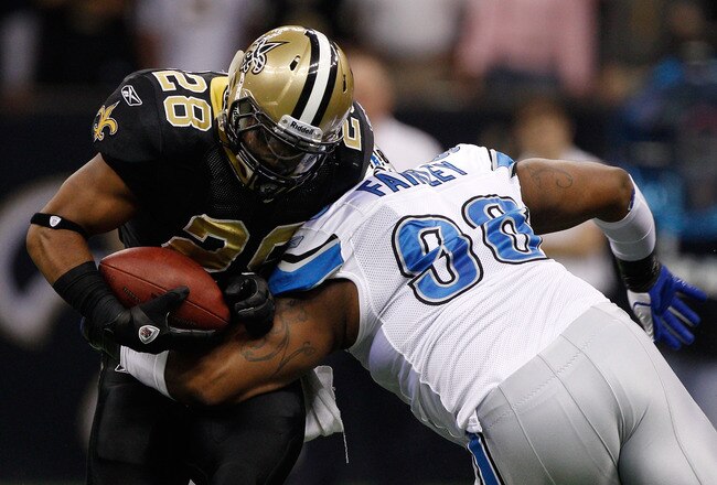 NEW ORLEANS, LA - DECEMBER 04:  Running back Mark Ingram #28 of the New Orleans Saints is hit by defensive tackle Nick Fairley #98 of the Detroit Lions in the first quarter at Mercedes-Benz Superdome on December 4, 2011 in New Orleans, Louisiana.  (Photo by Chris Graythen/Getty Images)