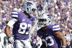 MANHATTAN, KS - OCTOBER 1: John Hubert #33 of the Kansas State Wildcats celebrates with Sheldon Smith #87 after scoring a touchdown in the first half against the Baylor Bears at Bill Snyder Family Football Stadium on October 1, 2011 in Manhattan, Kansas. The Wildcats won 36-35. (Photo by Joe Robbins/Getty Images)