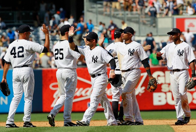 NEW YORK, NY - JULY 31:  Mariano Rivera #42 of the New York Yankees is congratulated by his teammates after he pitches in the ninth inning against the Baltimore Orioles on July 31, 2011 at Yankee Stadium in the Bronx borough of New York City. The Yankees defeated the Orioles 4-2. (Photo by Chris Trotman/Getty Images)