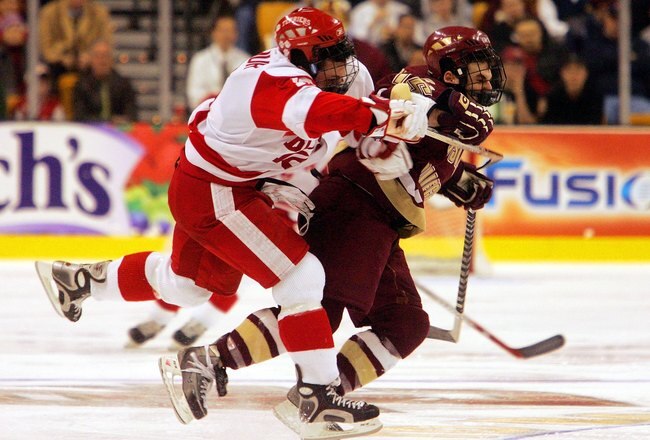 BOSTON - FEBRUARY 13 :  Stephen Gionta #15 of the Boston College Eagles is hit by Pete MacArthur #16 of the Boston University Terriers during the championship game of the 54th annual Beanpot tournament at the TD Banknorth Garden on February  13, 2006 in Boston, Massachusetts. The Terriers defeated the Eagles 3-2.(Photo by Jim McIsaac/Getty Images)