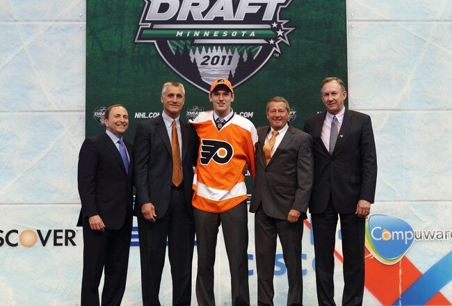 ST PAUL, MN - JUNE 24:  Eighth overall pick 	Sean Couturier by the Philadelphia Flyers stands with General Manager Paul Holmgren of the Philadelphia Flyers and a members of the Philadelphia Flyers organization onstage during day one of the 2011 NHL Entry Draft at Xcel Energy Center on June 24, 2011 in St Paul, Minnesota.  (Photo by Bruce Bennett/Getty Images)