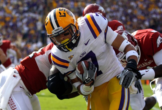 BATON ROUGE, LA - NOVEMBER 25:  Kick returner Tyrann Mathieu #7 of the LSU Tigers returns a punt for seven yards as he is tackled by Marquel Wade #1 of the Arkansas Razorbacks in the first quarter at Tiger Stadium on November 25, 2011 in Baton Rouge, Louisiana.  (Photo by Chris Graythen/Getty Images)