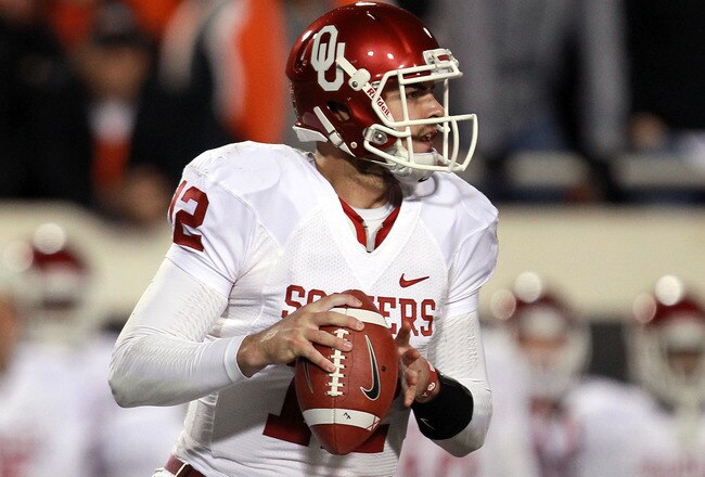 STILLWATER, OK - DECEMBER 03:  Landry Jones #12 of the Oklahoma Sooners throws against the Oklahoma State Cowboys at Boone Pickens Stadium on December 3, 2011 in Stillwater, Oklahoma.  (Photo by Ronald Martinez/Getty Images)