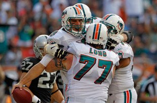 MIAMI GARDENS, FL - DECEMBER 04:  Matt Moore #8 of the Miami Dolphins celebrates a touchdown during a game against the Oakland Raiders at Sun Life Stadium on December 4, 2011 in Miami Gardens, Florida.  (Photo by Mike Ehrmann/Getty Images)