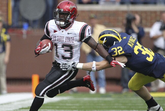 ANN ARBOR, MI - SEPTEMBER 24: Ronnie Hillman #13 of San Diego State runs for a first down as Jordan Kovacs #32 of the Michigan Wolverines attempts to make the stop runs during the first half of the game at Michigan Stadium on September 24, 2011 in Ann Arbor, Michigan.  (Photo by Leon Halip/Getty Images)