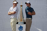 DUBAI, UNITED ARAB EMIRATES - DECEMBER 06:  Luke Donald of England and Rory McIlroy of Northern Ireland pictured with the Race to Dubai trophy during the pro-am event prior to the Dubai World Championships on the Earth Course at Jumeirah Golf Estates on December 6, 2011 in Dubai, United Arab Emirates.  (Photo by Ross Kinnaird/Getty Images)
