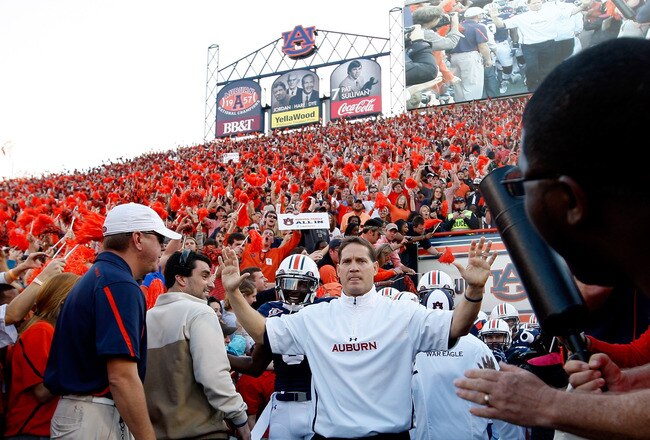 AUBURN, AL - NOVEMBER 26:  Head coach Gene Chizik of the Auburn Tigers leads his team onto the field to face the Alabama Crimson Tide at Jordan-Hare Stadium on November 26, 2011 in Auburn, Alabama.  (Photo by Kevin C. Cox/Getty Images)