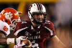COLUMBIA, SC - NOVEMBER 26:  Connor Shaw #14 of the South Carolina Gamecocks runs away from Rashard Hall #31 of the Clemson Tigers during their game at Williams-Brice Stadium on November 26, 2011 in Columbia, South Carolina.  (Photo by Streeter Lecka/Getty Images)