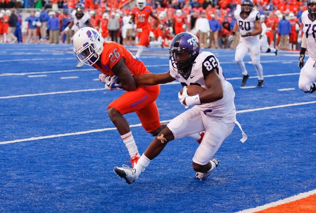 BOISE, ID - NOVEMBER 12:  Josh Boyce #82 of the TCU Horned Frogs pulls away from Quaylon Ewing-Burton #26 of the Boise State Broncos to score a two point conversion against the Boise State Broncos at Bronco Stadium on November 12, 2011 in Boise, Idaho.  The Horned Frogs won 36-35. (Photo by Otto Kitsinger III/Getty Images)