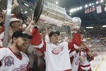 DETROIT, MI - JUNE 13:  Jesse Wallin of the Detroit Red Wings raises the Stanley Cup as he celebrates with Kris Draper (L) after eliminating the Carolina Hurricanes during game five of the NHL Stanley Cup Finals on June 13, 2002 at the Joe Louis Arena in Detroit, Michigan.  The Red Wings won 3-1.  (Photo by Elsa/Getty Images/NHLI)