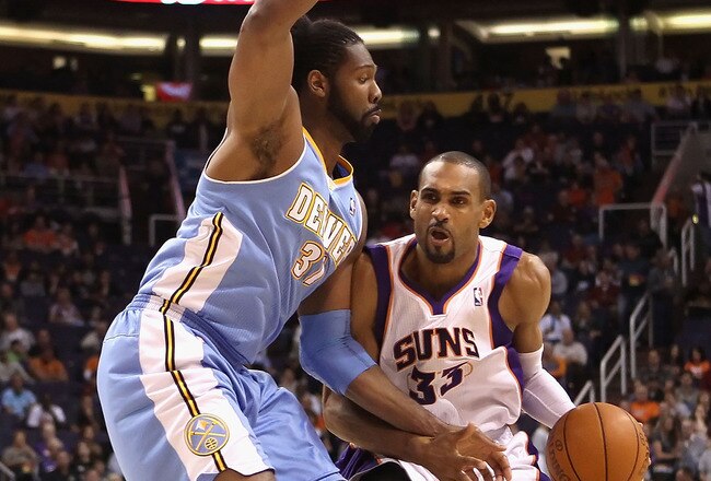 PHOENIX - NOVEMBER 15:  Grant Hill #33 of the Phoenix Suns handles the ball under pressure from Nene of the Denver Nuggets during the NBA game at US Airways Center on November 15, 2010 in Phoenix, Arizona. The Suns defeated the Nuggets 100-94.  NOTE TO USER: User expressly acknowledges and agrees that, by downloading and or using this photograph, User is consenting to the terms and conditions of the Getty Images License Agreement.  (Photo by Christian Petersen/Getty Images)