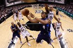 SAN ANTONIO - APRIL 29:  Forward Caron Butler #4 of the Dallas Mavericks takes a shot against Richard Jefferson #24 of the San Antonio Spurs in Game Six of the Western Conference Quarterfinals during the 2010 NBA Playoffs at AT&T Center on April 29, 2010 in San Antonio, Texas. NOTE TO USER: User expressly acknowledges and agrees that, by downloading and or using this photograph, User is consenting to the terms and conditions of the Getty Images License Agreement.  (Photo by Ronald Martinez/Getty Images)