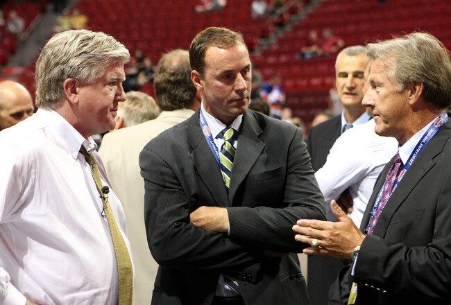 MONTREAL, QC - JUNE 26:  President & General Manager Brian Burke (L) and head coach Ron Wilson (R) of the Toronto Maple Leafs talk with Genral Manager Joe Nieuwendyk of the Dallas Stars prior to the first round of the 2009 NHL Entry Draft at the Bell Centre on June 26, 2009 in Montreal, Quebec, Canada.  (Photo by Bruce Bennett/Getty Images)
