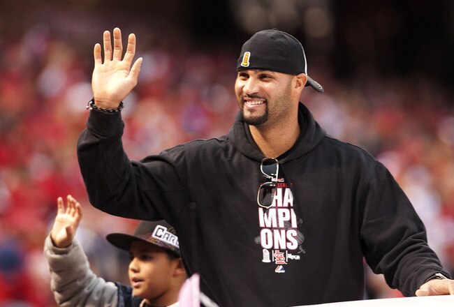 ST. LOUIS, MO - OCTOBER 30: First baseman Albert Pujols of the St. Louis Cardinals waves to the crowd during the World Series victory parade for the franchise's 11th championship on October 30, 2011 in St Louis, Missouri. (Photo by Ed Szczepanski/Getty Images)