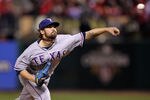ST LOUIS, MO - OCTOBER 28:  C.J. Wilson #36 of the Texas Rangers pitches in the sixth inning during Game Seven of the MLB World Series against the St. Louis Cardinals at Busch Stadium on October 28, 2011 in St Louis, Missouri.  (Photo by Ezra Shaw/Getty Images)