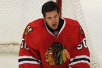 CHICAGO, IL - DECEMBER 05: Corey Crawford #50 of the Chicago Blackhawks reacts after getting hit in the face with the puck while making a save against  the Phoenix Coyotes at the United Center on December 5, 2011 in Chicago, Illinois. (Photo by Jonathan Daniel/Getty Images)