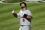 ARLINGTON, TX - OCTOBER 22:  Albert Pujols #5 of the St. Louis Cardinals celebrates after hitting a solo home run in the ninth inning for his third home run of the night during Game Three of the MLB World Series against the Texas Rangers at Rangers Ballpark in Arlington on October 22, 2011 in Arlington, Texas. The Cardinals won 16-7. (Photo by Ezra Shaw/Getty Images)