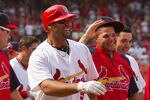 ST. LOUIS, MO - JUNE 5: Albert Pujols #5 and Yadier Molina #4 both of the St. Louis Cardinals leave the field after Pujols' walk-off home run against the Chicago Cubs with teammates at Busch Stadium on June 5, 2011 in St. Louis, Missouri.  The Cardinals beat the Cubs 3-2 in 10 innings.  (Photo by Dilip Vishwanat/Getty Images)