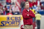 LITTLE ROCK, AR - NOVEMBER 19:   Head Coach Bobby Petrino and the Arkansas Razorbacks watches his team warm up before a game against the Mississippi State Bulldogs at War Memorial Stadium on November 19, 2011 in Little Rock, Arkansas. The Razorbacks defeated the Bulldogs 44-17.  (Photo by Wesley Hitt/Getty Images)