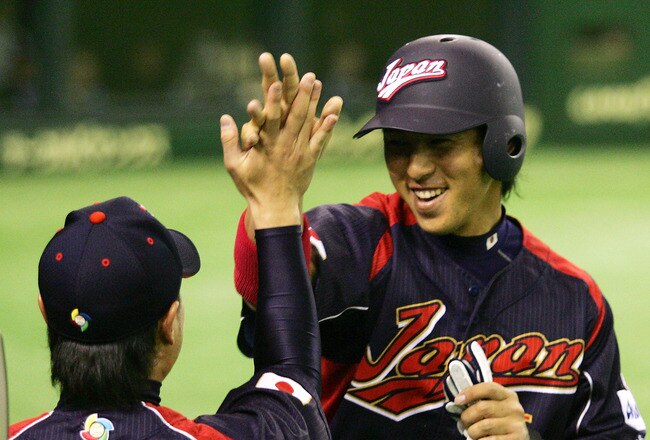TOKYO - MARCH 07:  Infielder Hiroyuki Nakajima #6 of Japan celebrates scoring with teammate Yoshiyuki Kamei #35 after Outfielder Seiichi Uchikawa's two-run single in the top of the first inning during the World Baseball Classic Tokyo Round match  between Japan and South Korea at Tokyo Dome on March 7, 2009 in Tokyo, Japan.  (Photo by Koji Watanabe/Getty Images)