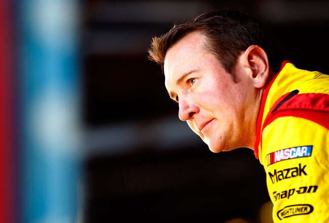 TALLADEGA, AL - OCTOBER 21:  Kurt Busch, driver of the #22 Shell/Pennzoil Dodge, stands in the garage area during practice for the NASCAR Sprint Cup Series Good Sam Club 500 at Talladega Superspeedway on October 21, 2011 in Talladega, Alabama.  (Photo by Jeff Zelevansky/Getty Images for NASCAR)