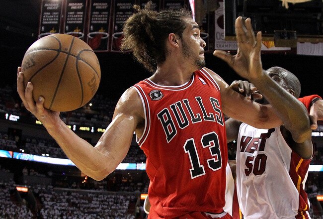 MIAMI, FL - MAY 22:  Joakim Noah #13 of the Chicago Bulls looks to pass the ball against Joel Anthony #50 of the Miami Heat in Game Three of the Eastern Conference Finals during the 2011 NBA Playoffs on May 22, 2011 at American Airlines Arena in Miami, Florida.  NOTE TO USER: User expressly acknowledges and agrees that, by downloading and or using this photograph, User is consenting to the terms and conditions of the Getty Images License Agreement.  (Photo by Mike Ehrmann/Getty Images)