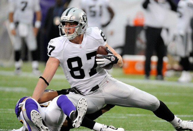 MINNEAPOLIS, MN - NOVEMBER 20: Kevin Boss #87 of the Oakland Raiders is taken down by Tyrell Johnson #25 of the Minnesota Vikings in the first quarter on November 20, 2011 at Hubert H. Humphrey Metrodome in Minneapolis, Minnesota. (Photo by Hannah Foslien/Getty Images)
