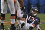 CHICAGO, IL - DECEMBER 04:  Caleb Hanie #12 of the Chicago Bears is helped to his feet by Lance Louis #60 after being sacked by the Kansas City Chiefs at Soldier Field on December 4, 2011 in Chicago, Illinois. The Chiefs defeated the Bears 10-3. (Photo by Jonathan Daniel/Getty Images)