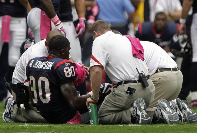 HOUSTON, TX - OCTOBER 02: Wide receiver Andre Johnson #80 of the Houston Texans is seen by team doctors after he pulled his hamstring against the Pittsburgh Steelers on October 2, 2011 at Reliant Stadium in Houston, Texas.Johnson left the game becasue of the injury. Texans won 17 to 10. (Photo by Thomas B. Shea/Getty Images)