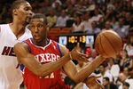 MIAMI, FL - MARCH 25:  Forward Thaddeus Young #21 of the Philadelphia Sixers drives against Forward Chris Bosh #1 of the Miami Heat at American Airlines Arena on March 25, 2011 in Miami, Florida. The Heat defeated the Sixers 111-99. NOTE TO USER: User expressly acknowledges and agrees that, by downloading and/or using this Photograph, User is consenting to the terms and conditions of the Getty Images License Agreement.  (Photo by Marc Serota/Getty Images)