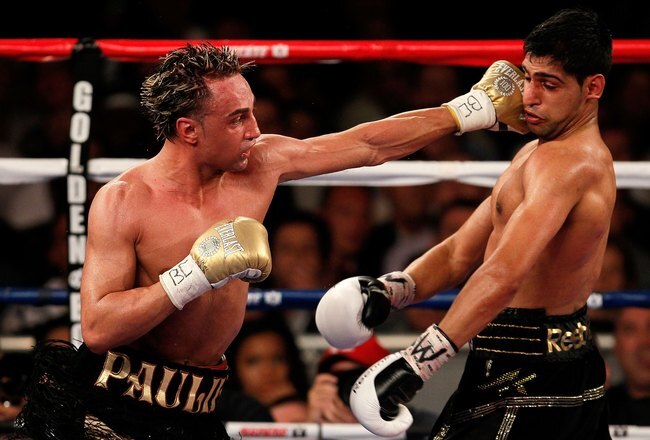 NEW YORK - MAY 15:   Paulie Malignaggi (L) hits Amir Khan of Great Britain during the WBA light welterweight title fight at Madison Square Garden on May 15, 2010 in New York City.  (Photo by Chris Trotman/Getty Images)