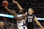 DENVER, CO - MARCH 19:  Charles Abouo #1 of the Brigham Young Cougars goes to the hoop against Mathis Monninghoff #22 of the Gonzaga Bulldogs during the third round of the 2011 NCAA men's basketball tournament at Pepsi Center on March 19, 2011 in Denver, Colorado.  (Photo by Justin Edmonds/Getty Images)