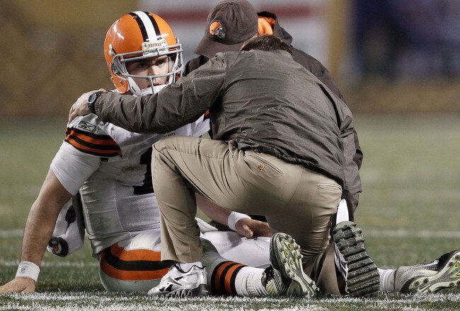 PITTSBURGH, PA - DECEMBER 08:  Colt McCoy #12 of the Cleveland Browns lays on the ground while speaking to athletic trainers after a helmet to helmet hit from James Harrison #92 of the Pittsburgh Steelers during the game on December 8, 2011 at Heinz Field in Pittsburgh, Pennsylvania.  (Photo by Jared Wickerham/Getty Images)