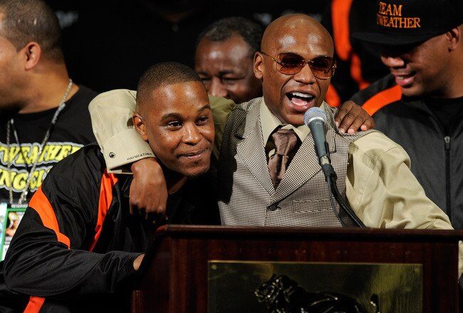 LAS VEGAS, NV - SEPTEMBER 17:  Boxer Floyd Mayweather Jr. (R) hugs his cousin and camp coordinator DeJuan Blake during a post-fight news conference after Mayweather defeated Victor Ortiz to win the WBC welterweight title at the MGM Grand Garden Arena September 17, 2011 in Las Vegas, Nevada.  (Photo by Ethan Miller/Getty Images)