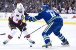VANCOUVER, CANADA - NOVEMBER 20: Jesse Winchester #18 of the Ottawa Senators tries to get past Andrew Alberts #41 of the Vancouver Canucks during NHL action on November 20, 2011 at Rogers Arena in Vancouver, British Columbia, Canada.  (Photo by Rich Lam/Getty Images)