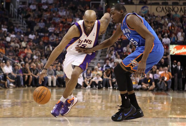 PHOENIX, AZ - MARCH 30:  Vince Carter #25 of the Phoenix Suns drives the ball past Kevin Durant #35 of the Oklahoma City Thunder during the NBA game at US Airways Center on March 30, 2011 in Phoenix, Arizona.  The Thunder defeated the Suns 116-98.  NOTE TO USER: User expressly acknowledges and agrees that, by downloading and or using this photograph, User is consenting to the terms and conditions of the Getty Images License Agreement.  (Photo by Christian Petersen/Getty Images)