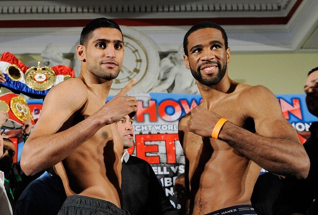 WASHINGTON, DC - DECEMBER 09:  Unified Light-Welterweight Champion of the World Amir Khan and Lamont Peterson stand for photos during the official weigh-in for the Capital Showdown: Khan v Peterson at the Carnegie Library on December 9, 2011 in Washington, DC.  (Photo by Patrick McDermott/Getty Images)