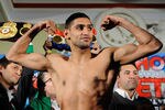WASHINGTON, DC - DECEMBER 09:  Unified Light-Welterweight Champion of the World Amir Khan takes part in the the official weigh-in for the Capital Showdown: Khan v Peterson at the Carnegie Library on December 9, 2011 in Washington, DC.  (Photo by Patrick McDermott/Getty Images)