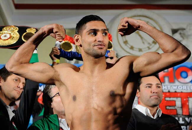 WASHINGTON, DC - DECEMBER 09:  Unified Light-Welterweight Champion of the World Amir Khan takes part in the the official weigh-in for the Capital Showdown: Khan v Peterson at the Carnegie Library on December 9, 2011 in Washington, DC.  (Photo by Patrick McDermott/Getty Images)
