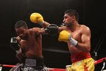 WASHINGTON, DC - DECEMBER 10:  Amir Khan and Lamont Peterson exchange punches during their WBA Super Lightweight and IBF Junior Welterweight title fight at Washington Convention Center on December 10, 2011 in Washington, DC.  (Photo by Al Bello/Getty Images)