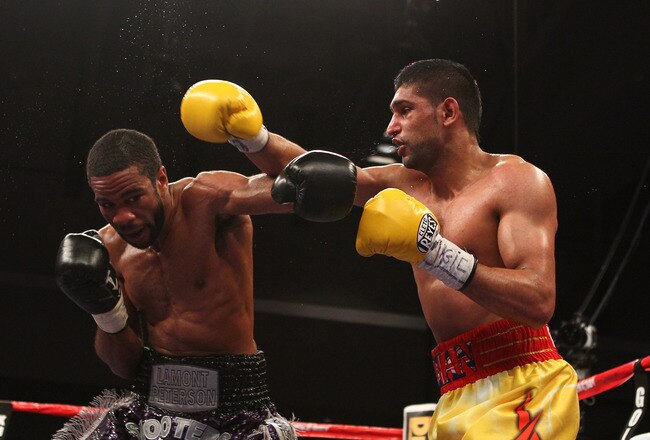 WASHINGTON, DC - DECEMBER 10:  Amir Khan and Lamont Peterson exchange punches during their WBA Super Lightweight and IBF Junior Welterweight title fight at Washington Convention Center on December 10, 2011 in Washington, DC.  (Photo by Al Bello/Getty Images)