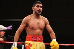 WASHINGTON, DC - DECEMBER 10:  Amir Khan walks back to his corner between rounds against Lamont Peterson during their WBA Super Lightweight and IBF Junior Welterweight title fight at Washington Convention Center on December 10, 2011 in Washington, DC.  (Photo by Al Bello/Getty Images)