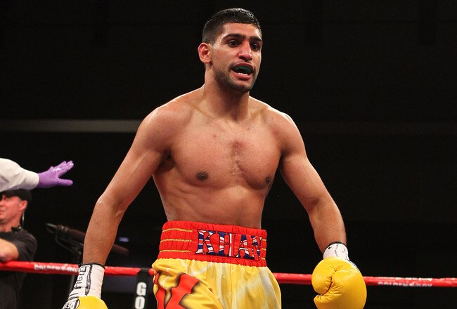 WASHINGTON, DC - DECEMBER 10:  Amir Khan walks back to his corner between rounds against Lamont Peterson during their WBA Super Lightweight and IBF Junior Welterweight title fight at Washington Convention Center on December 10, 2011 in Washington, DC.  (Photo by Al Bello/Getty Images)