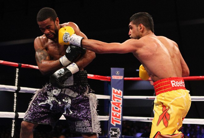 WASHINGTON, DC - DECEMBER 10:  Amir Khan punches Lamont Peterson during their WBA Super Lightweight and IBF Junior Welterweight title fight at Washington Convention Center on December 10, 2011 in Washington, DC.  (Photo by Al Bello/Getty Images)