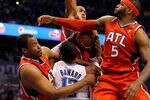 ORLANDO, FL - APRIL 16:  Jason Collins #34 (left), Al Horford #15 (center) and Josh Smith #5 of the Atlanta Hawks defend Dwight Howard #12 of the Orlando Magic during Game One of the Eastern Conference Quarterfinals of the 2011 NBA Playoffs on April 16, 2011 at the Amway Arena in Orlando, Florida.  NOTE TO USER: User expressly acknowledges and agrees that, by downloading and/or using this Photograph, user is consenting to the terms and conditions of the Getty Images License Agreement.  (Photo by J. Meric/Getty Images)