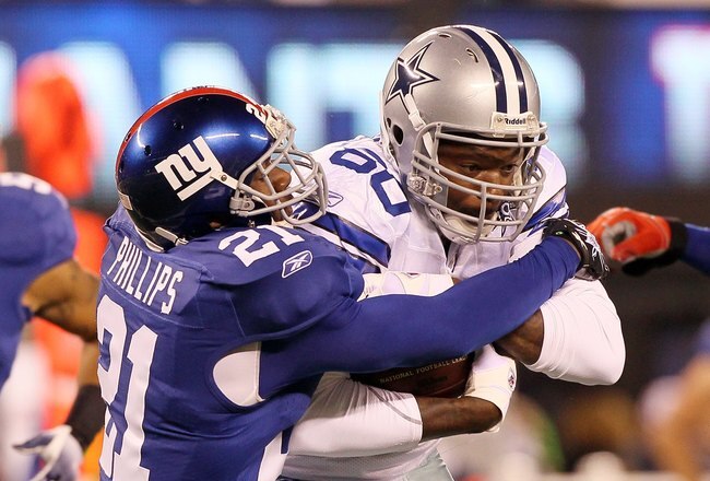 EAST RUTHERFORD, NJ - NOVEMBER 14:  Martellus Bennett #80 of the Dallas Cowboys is tackled by Kenny Phillips #21 of the New York Giants on November 14, 2010 at the New Meadowlands Stadium in East Rutherford, New Jersey.  (Photo by Jim McIsaac/Getty Images)