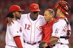 CINCINNATI, OH - SEPTEMBER 14:  Dusty Baker #12 (center) the Manager of the Cincinnati Reds has his arm around Johnny Cueto #47 (left) while pulling the pitcher from the game against the Chicago Cubs at Great American Ball Park on September 14, 2011 in Cincinnati, Ohio.  Cueto injured himself while pitching.  (Photo by Andy Lyons/Getty Images)