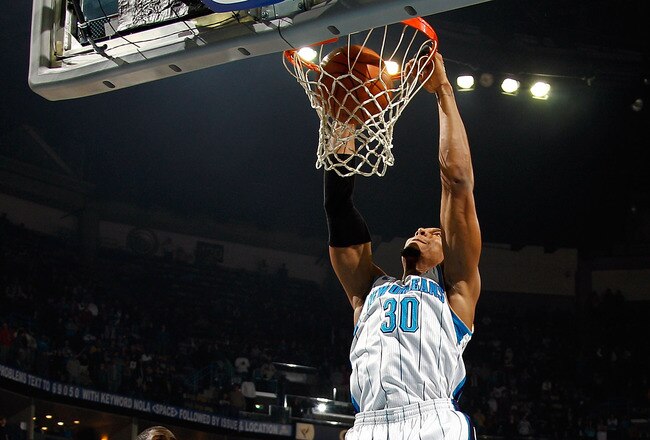 NEW ORLEANS, LA - DECEMBER 26:  David West #30 of the New Orleans Hornets dunks the ball over Marvin Williams #24 of the Atlanta Hawks at the New Orleans Arena on December 26, 2010 in New Orleans, Louisiana.  NOTE TO USER: User expressly acknowledges and agrees that, by downloading and or using this photograph, User is consenting to the terms and conditions of the Getty Images License Agreement.  (Photo by Chris Graythen/Getty Images)