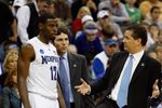 KANSAS CITY, MO - MARCH 21:   Tyreke Evans #12 of the Memphis Tigers looks on as head coach John Calipari stands on one leg during the second round of the NCAA Division I Men's Basketball Tournament at the Sprint Center on March 21, 2009 in Kansas City, Missouri. The Tigers defeated the Terrapins 89-70.  (Photo by Jamie Squire/Getty Images)