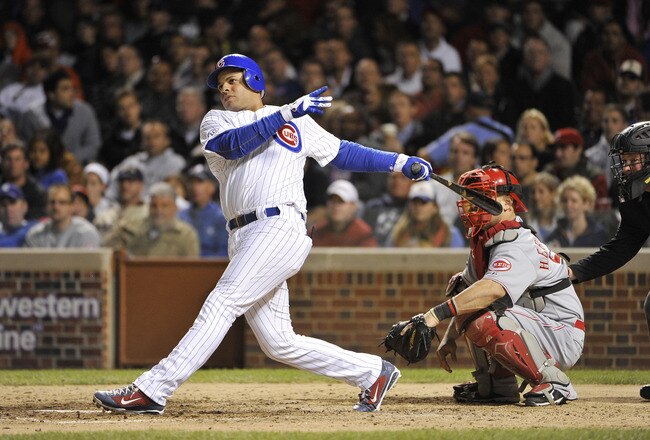 CHICAGO, IL - SEPTEMBER 07:  Aramis Ramirez #16 of the Chicago Cubs follows through on a two-RBI double scoring teammates Starlin Castro #13 and Reed Johnson #5 during the sixth inning against the Cincinnati Reds at Wrigley Field on September 7, 2011 in Chicago, Illinois.  (Photo by Brian Kersey/Getty Images)